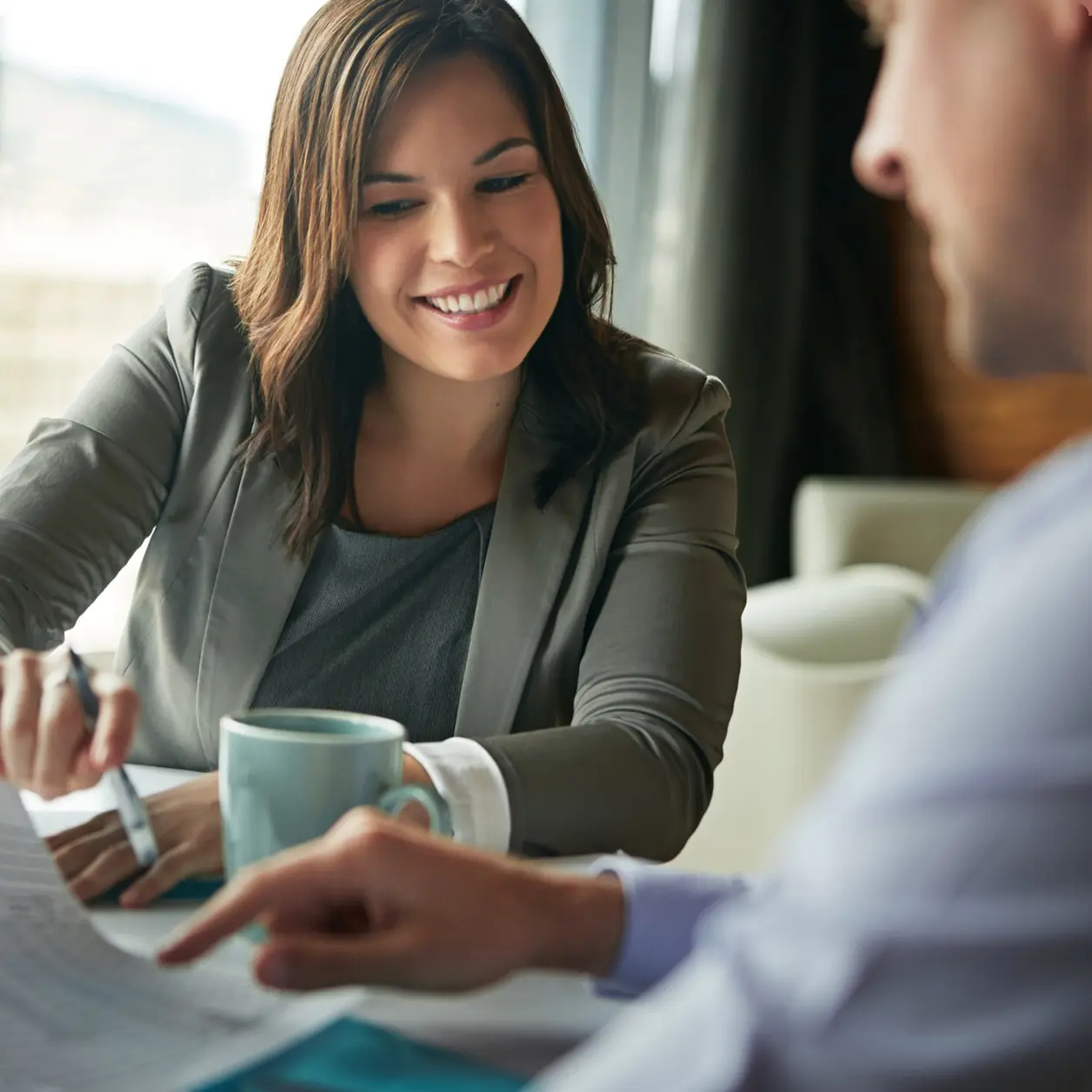 Business advisor smiling while talking a client through their figures